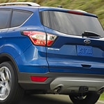 a close up shot of the back of a blue ford escape 