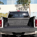 image of the back of a white ford truck with its bed open 