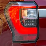 closeup of a red fords left rear headlight 