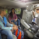 an interior shot of an suv with a family inside talking to each other 
